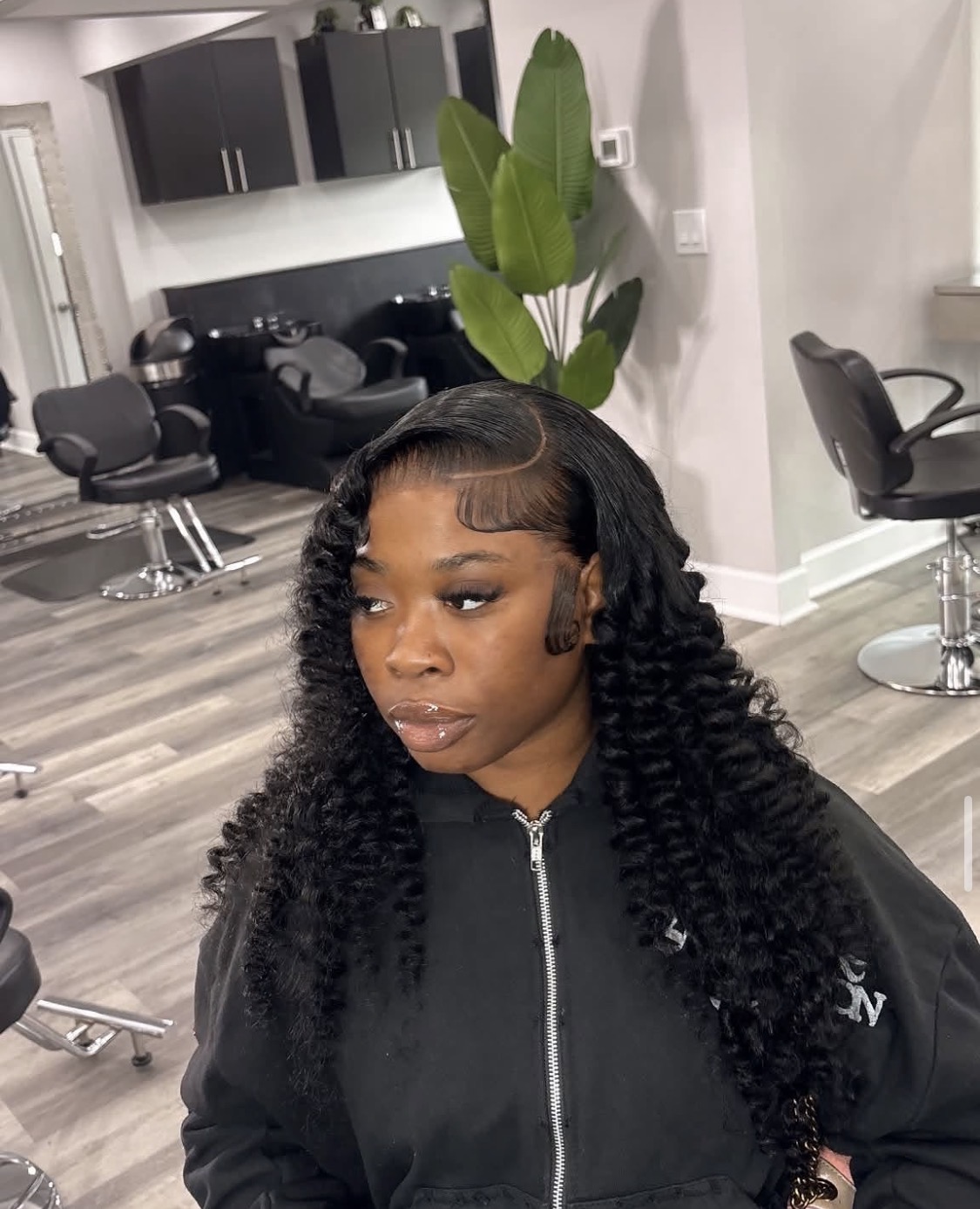 Deep wave curls styled with sleek swooped edges